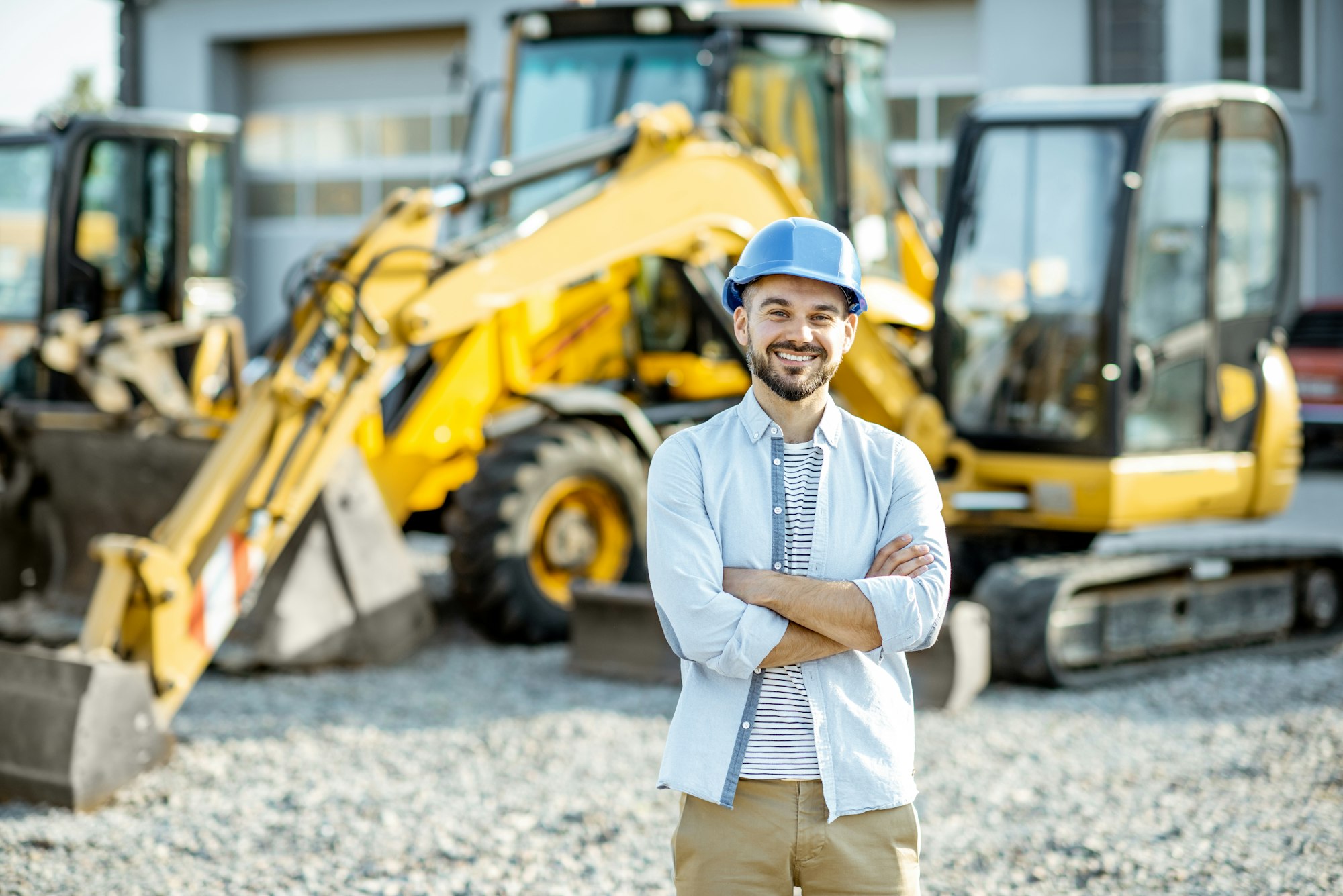 Builder at the shop with heavy machinery