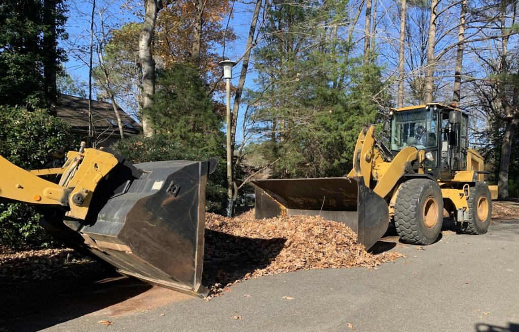 City’s trucks collecting Fall leaves at neighborhood homes curbs where they have to leave them.