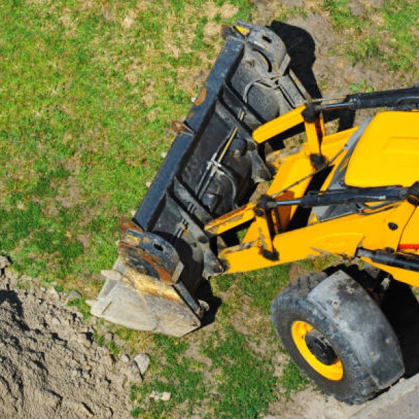 Contemporary yellow bulldozer on road construction site